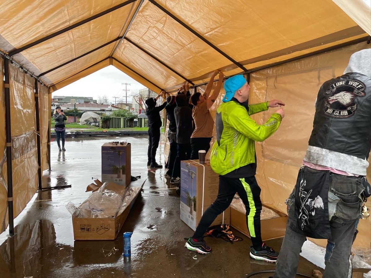 Activists assemble a canvas tent. 