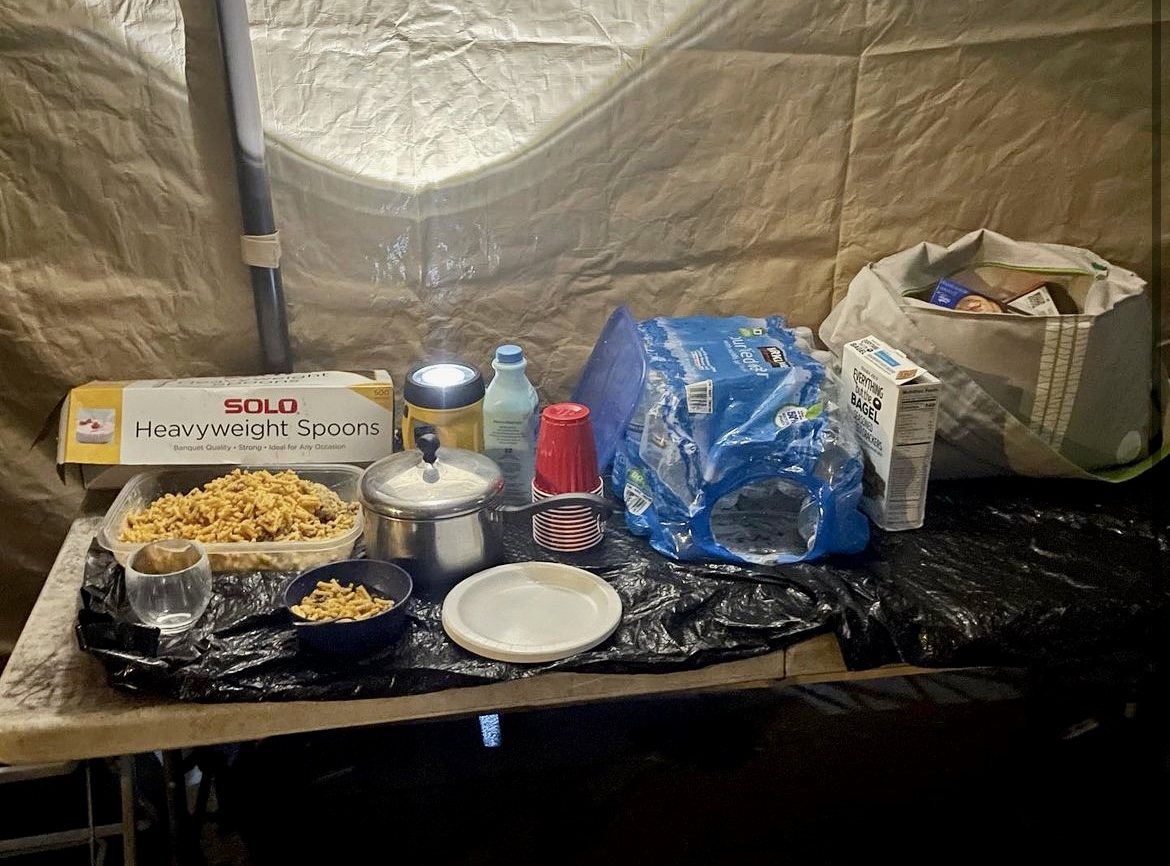 Food and bottled water on a foldable table.