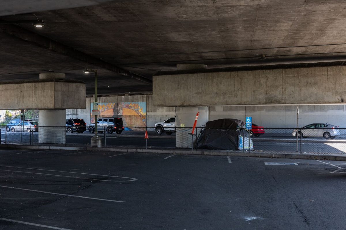 The empty parking lot along Lakeshore Avenue under Interstate 580