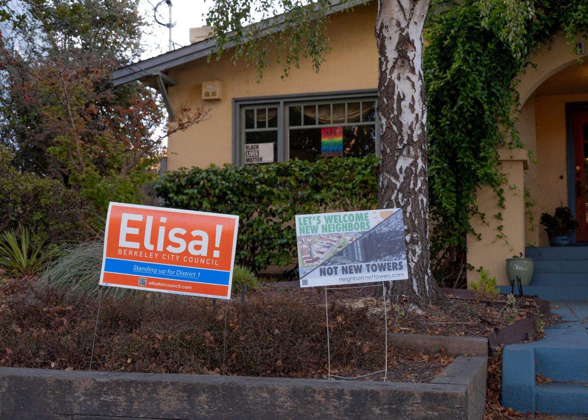 Two yard signs sit in front of a North Berkeley home, one calling for "neighbors not new towers" at the nearby BART station, the other supporting Elisa Mikiten's campaign for City Council