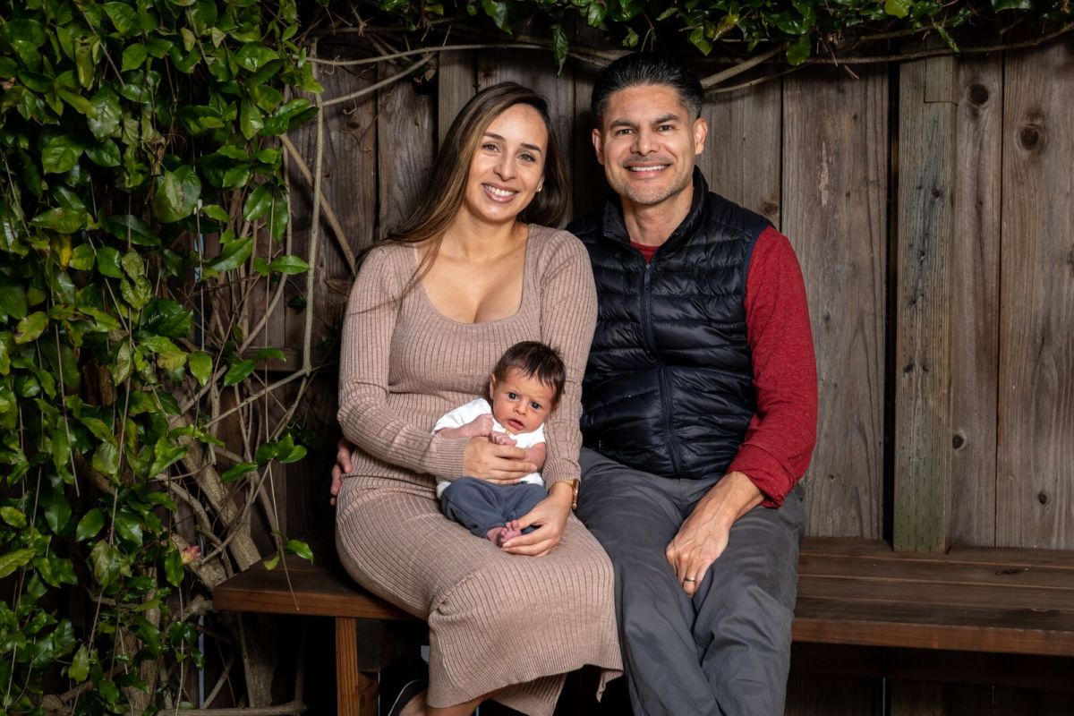 Carlos Velasquez, Graciela Galvez, and their baby Matias pose for a photo at their Berkeley home on January 24, 2022. Credit: Kelly Sullivan