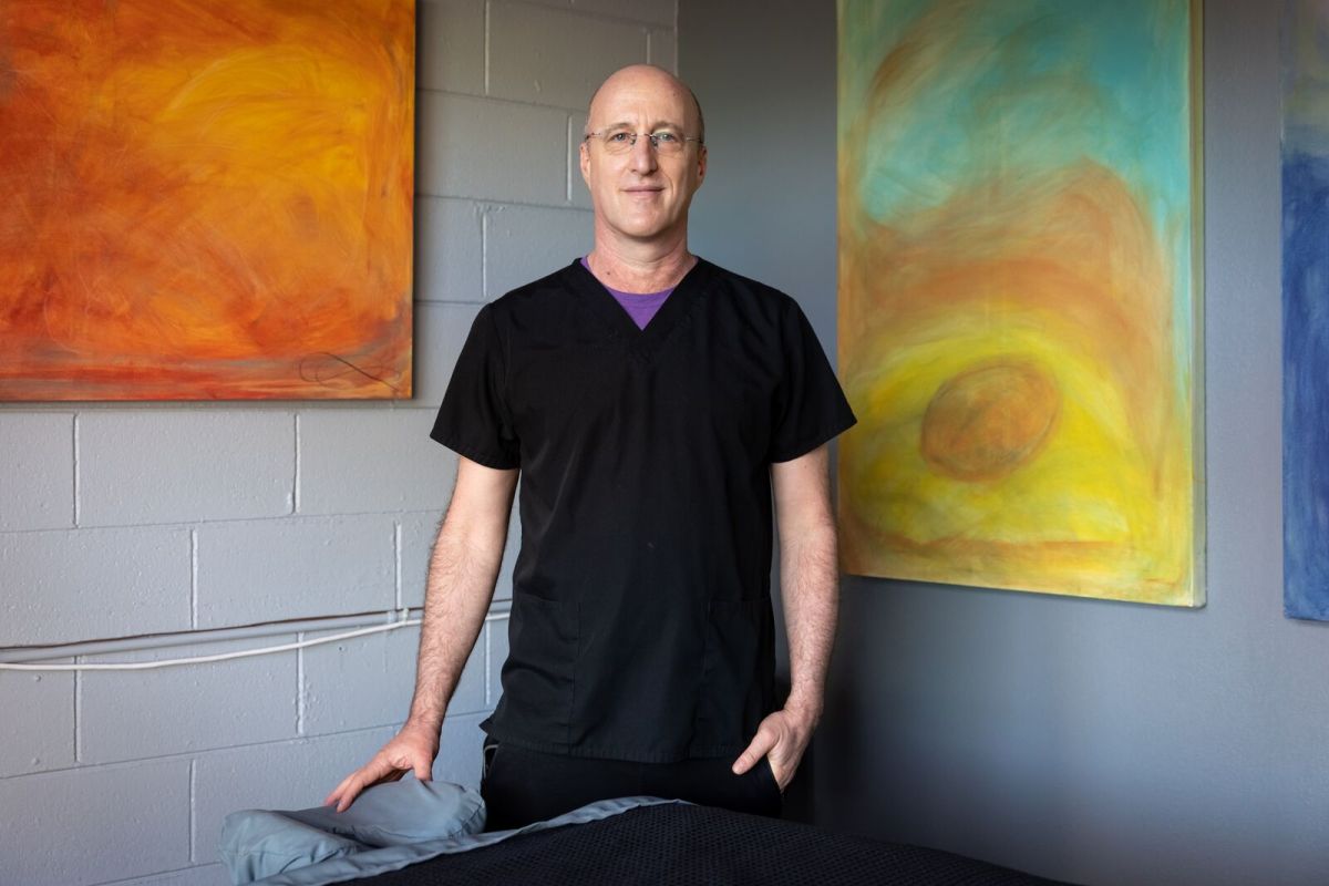 Massage therapist Alex Schoenfeldt poses for a photo at Berkeley Deep Sports Massage on February 8, 2022. Credit: Kelly Sullivan